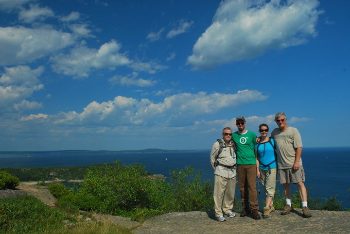 mr. james poses for a picture with his late father, wife, and father-in-law while hiking in acadia national park in 2011.